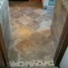 13x13 porcelain tile set on diagonal with door transition leading into bathrrom