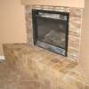 Fireplace bench in 4x4 travertine square lay with stacked stone placed around fireplace