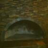 Arch ledger panel fireplace with a 12 x 12 slate hearth.