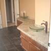 Granite counter top in master bathroom with unique angles and vessal sinks. 4" inch backsplash mosaic.