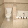 Master bathroom tubsurround and waines coat with a granite tile border.