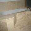 unique tub deck with stem done in travertine and chair rails for edging.