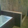 1/2 x 1/2 inch travertine mosaic tile on tubsurround and stem wall  a 16 x 16 porcelain tile on shower walls.